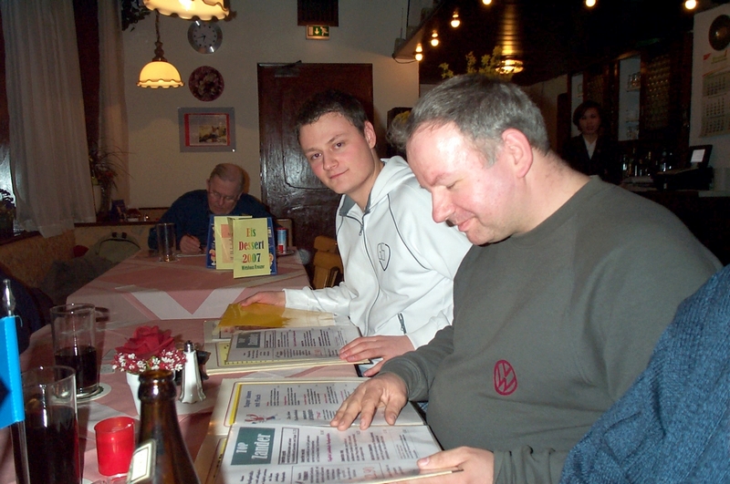 crossmaster and balibennie study the menu card.