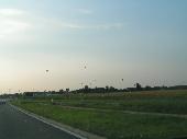 <b>Day 2 - Balloons </b><br />This is a bit of a joke. It's a picture I took through the windshield of my car - while driving, I never heard of a ban on hands-on photography... ;) - as I was driving back to my parent's place in Zeeuws-Vlaanderen. This must have been somewhere between St. Gillis Waas and the border. I couldn't really zoom or focus or anything, I just picked up the camera, pointed it roughly in the right direction and pressed the button... It was quite an impressive sight, all these balloons suddenly appearing on the horizon.