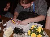 Licht&Feuer writing down his bills.
