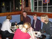 Henriika (white shirt) and imleH (red shirt), and on the other side of the table are aplfi, KimmoJ and Dakkus